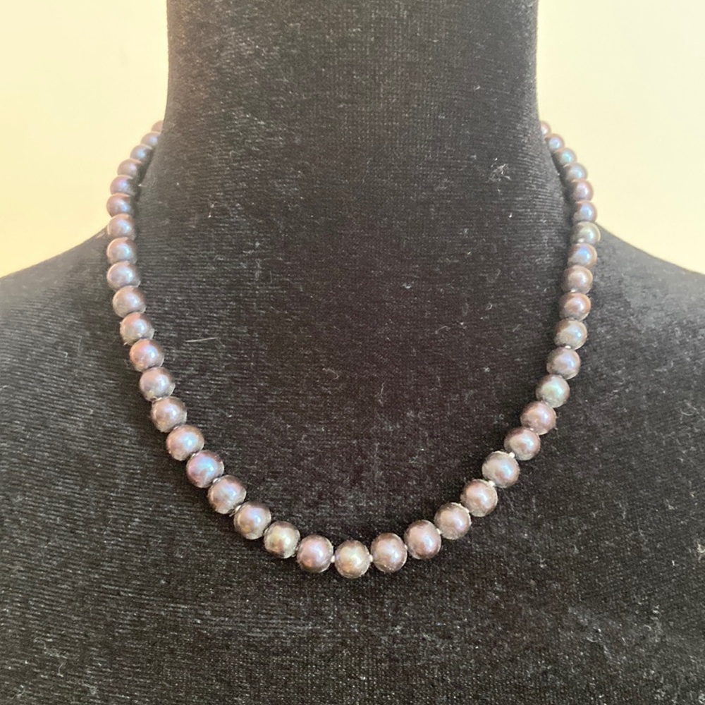 This necklace is almost an iridescent black. Great piece for work!